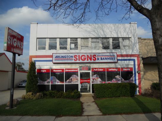 Arlington Signs and Banners.  We combined graphic waves of colorful images, solid bands of text and two lighted signs to create a visually stunning storefront and stand out from the rest.